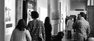 Visitors to Strategy: Get Arts (1970) inspecting work along the first-floor south corridor (from E.22 to E.25). Photo