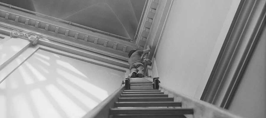 Blinky Palermo making his wall painting Blue/Yellow/White/Red (August 1970). Photo