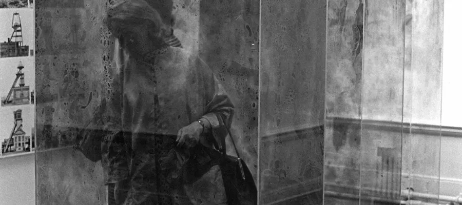 The art critic Cordelia Oliver among glass containers by Erich Reusch and photographs by Bernd and Hilla Becher in studio E.25