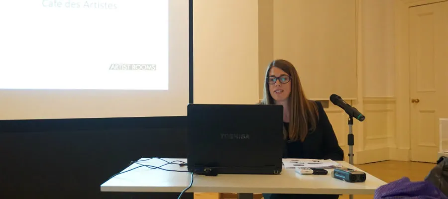 Lucy Askew at Café des Artistes number 12 discussing Roy Lichtenstein.