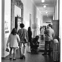 Visitors to Strategy: Get Arts (1970) inspecting work along the first-floor south corridor (from E.22 to E.25). Photo