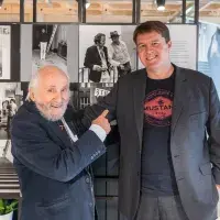 Richard Demarco and Christian Weikop in front of SGA photo-display created by Studies in Photography for ECA Café. Photo