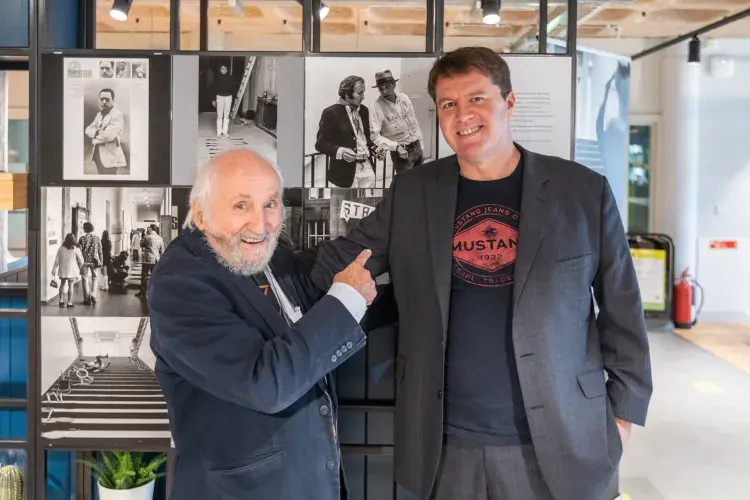 Richard Demarco and Christian Weikop in front of SGA photo-display created by Studies in Photography for ECA Café. Photo